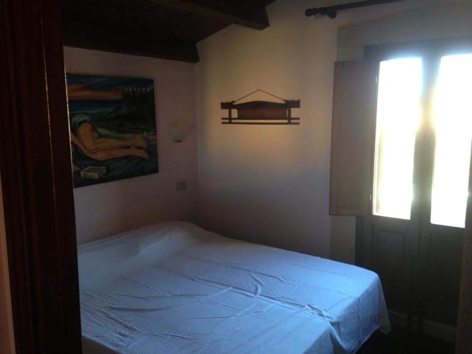 拉斯卡里Le 3 tartarughe的一间带床的卧室,位于带窗户的房间内