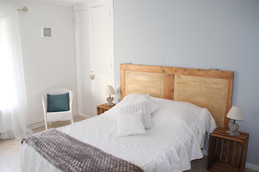 Maisoncelle瑞博思若伊住宿加早餐旅馆的卧室配有白色的床和蓝色椅子