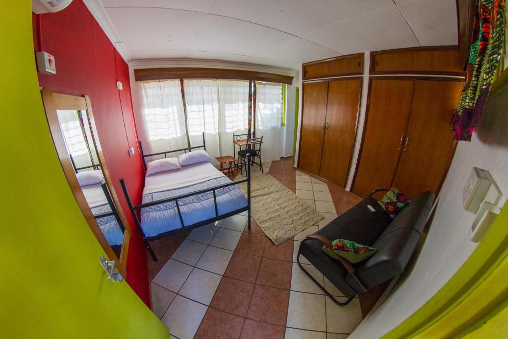 莫希We Travel Hostel的小房间设有床和沙发