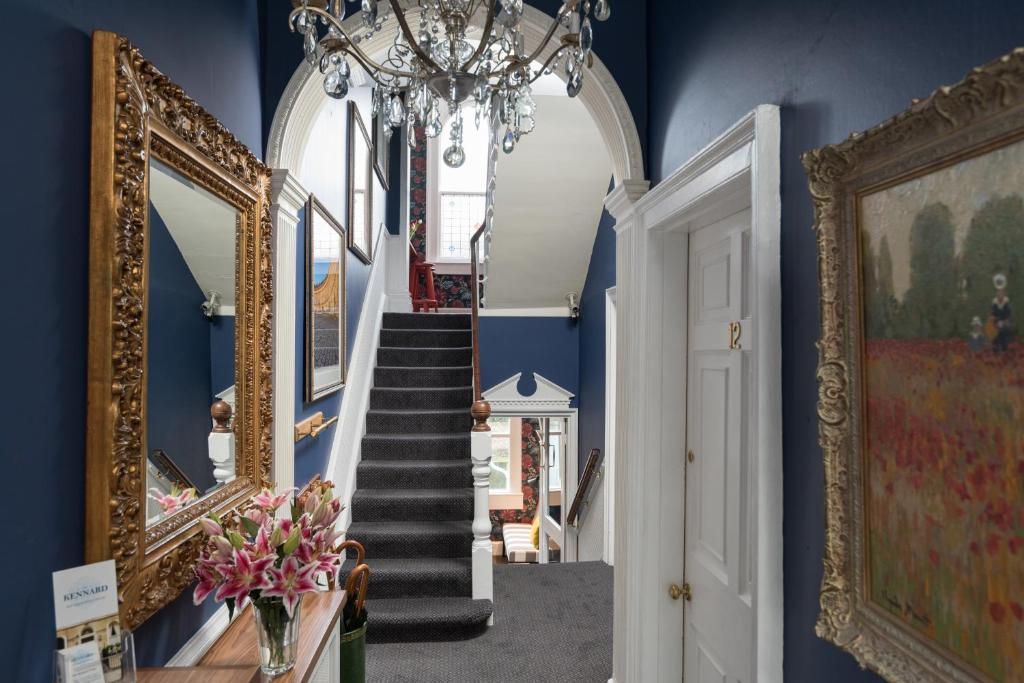 巴斯The Kennard Boutique Guesthouse的走廊设有蓝色的墙壁和吊灯