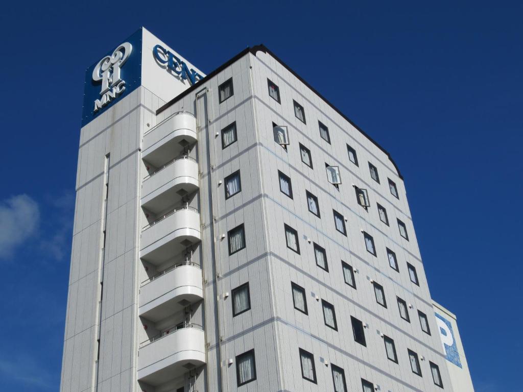 三原市三原中心酒店的一座高大的白色建筑,上面有标志