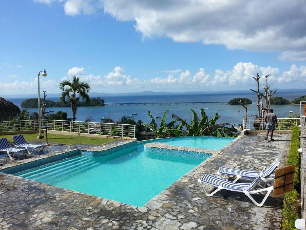 圣塔芭芭拉-山美纳Hidden Paradise at Apto Del Cerro的一个带椅子的游泳池,享有水景