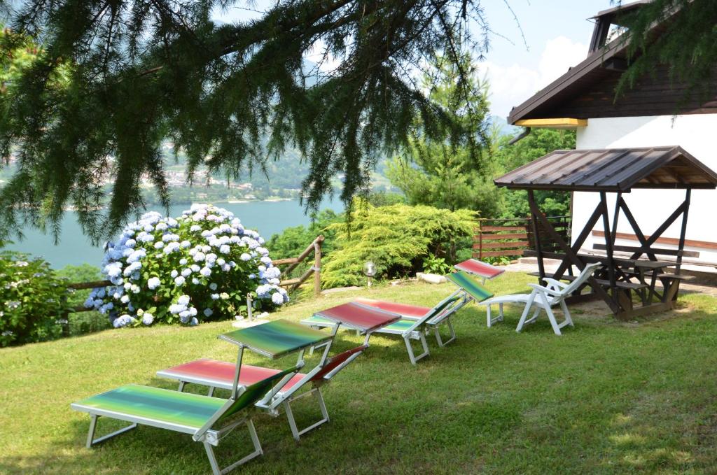 Tenna Trentino Appartamenti Oss的一组草坪椅和一个凉亭