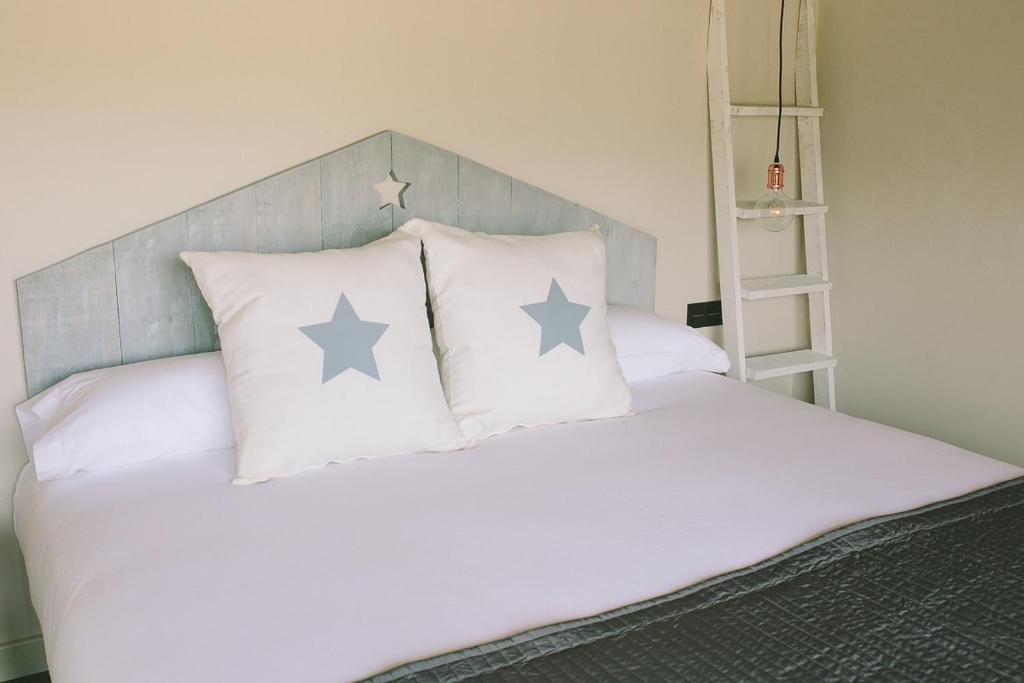 贝哈尔ALTAIR Turismo Rural的一张带四个枕头的床,上面有星星