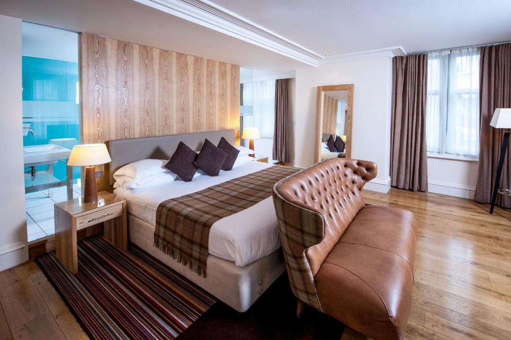 坎特伯雷坎特伯雷大住宿酒店的配有一张床和一把椅子的酒店客房