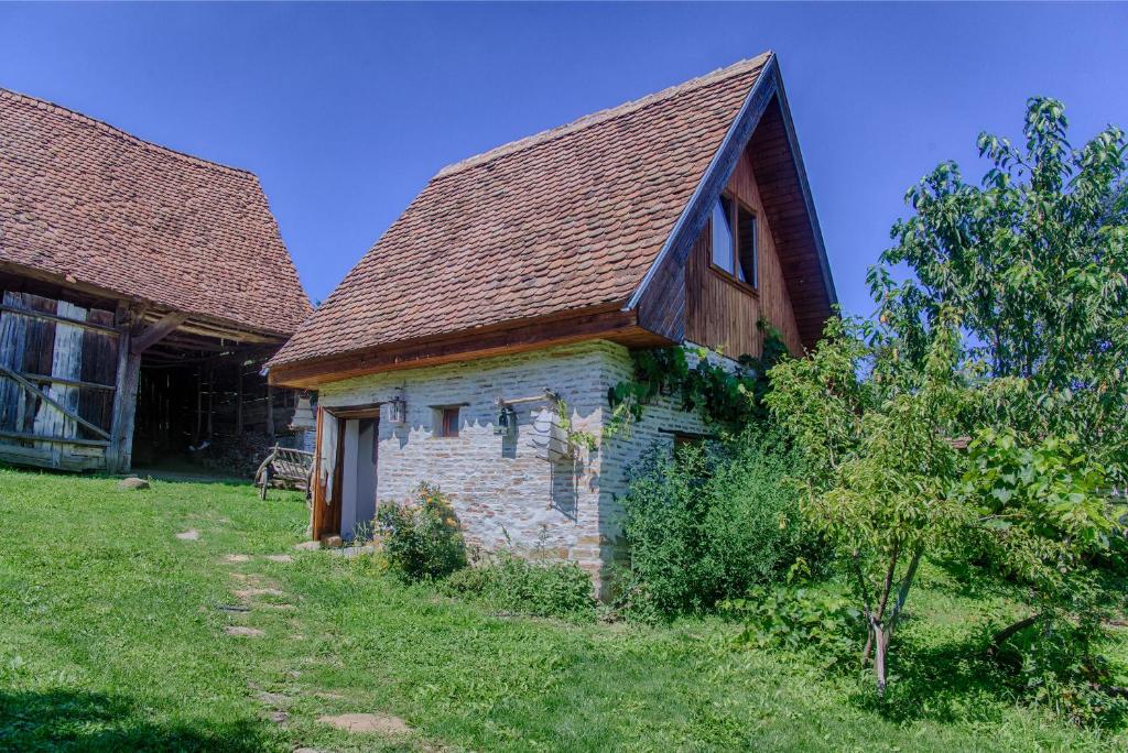 CloaşterfDominic Boutique - Gardener's Cottage的一座带棕色屋顶的古老石屋
