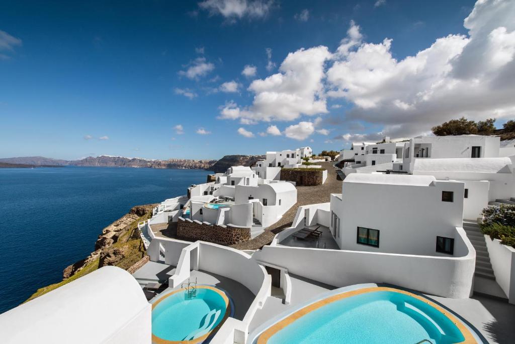 阿克罗蒂里Grand Ambassador Santorini Hotel的享有白色建筑和大海的景色