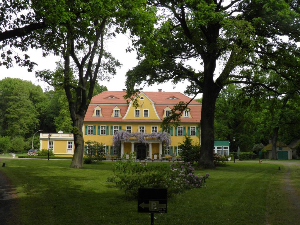LohsaFledermausschloss的草坪上一座黄色房子,屋顶红色