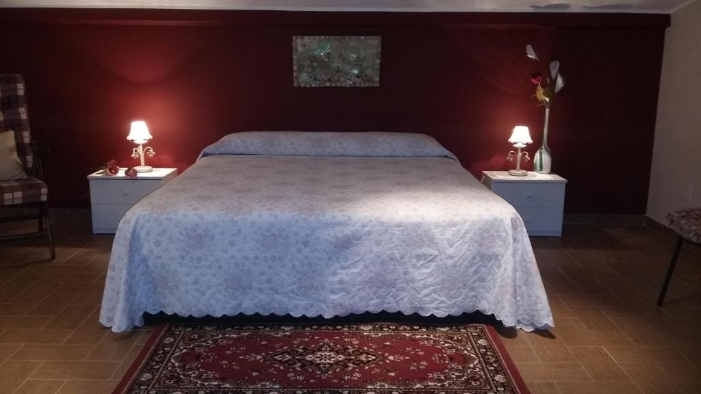 马斯卡利Etna Sun Guest House的一间卧室配有一张带2个床头柜的大床