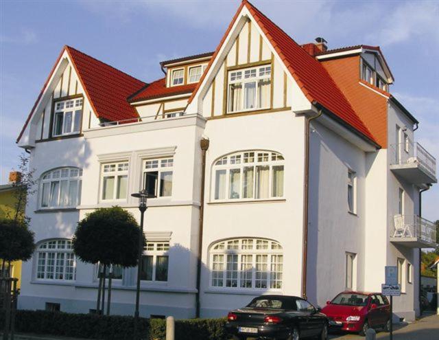 奥斯赛拜-屈隆斯博恩Appartementhaus Plueckhahn的一座大型白色房屋,设有红色屋顶
