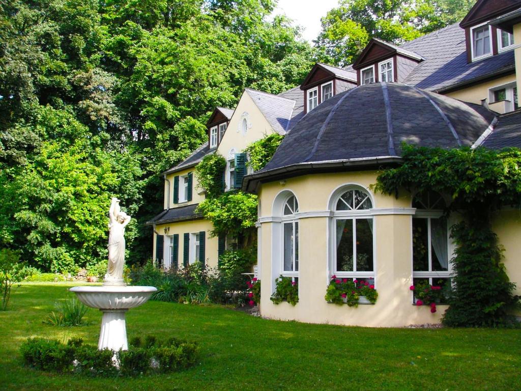施默尔恩贝勒维施莫林餐厅&酒店的院子里有雕像的大房子