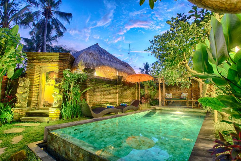 乌布巴厘岛幻想假日公园的一座带房子的庭院内的游泳池