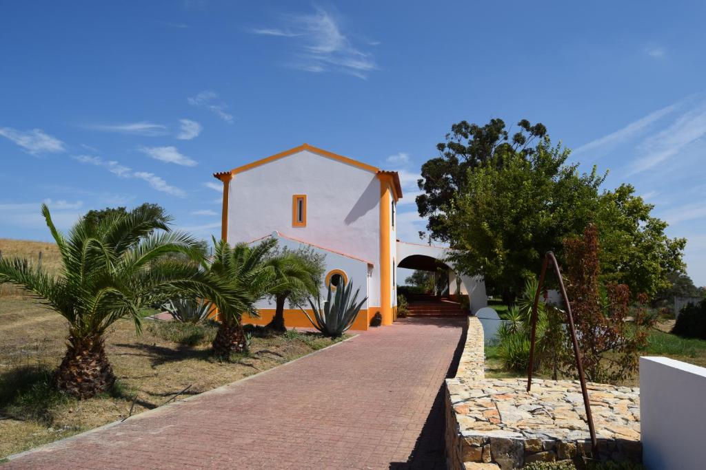 埃武拉Quinta da Aurora的一条白色的小房子,有一条通往房子的路径
