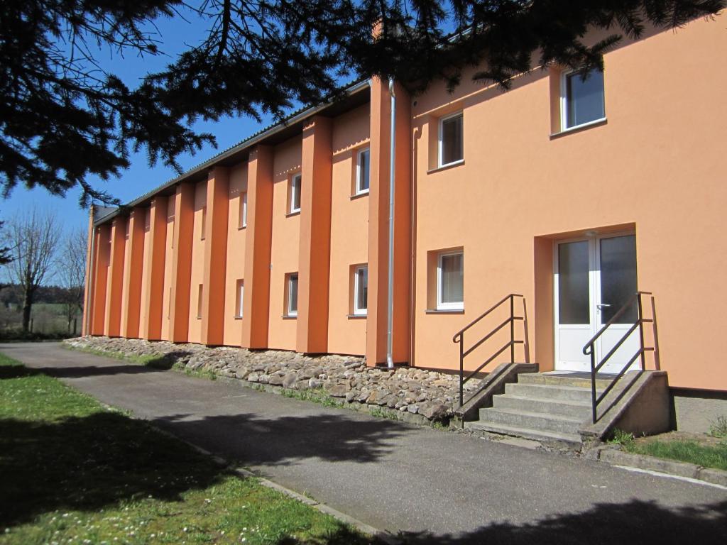 FryšavaPenzion Fryšavský ledovec的一座橙色的大建筑,前面设有楼梯
