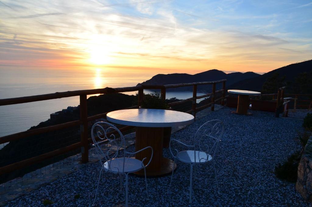 韦尔纳扎凯德文图旅馆的日落时分带2张桌子和椅子的庭院