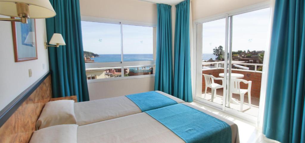 罗列特海岸Hotel Gran Garbi Mar & AquaSplash的酒店客房设有一张床和一个大窗户