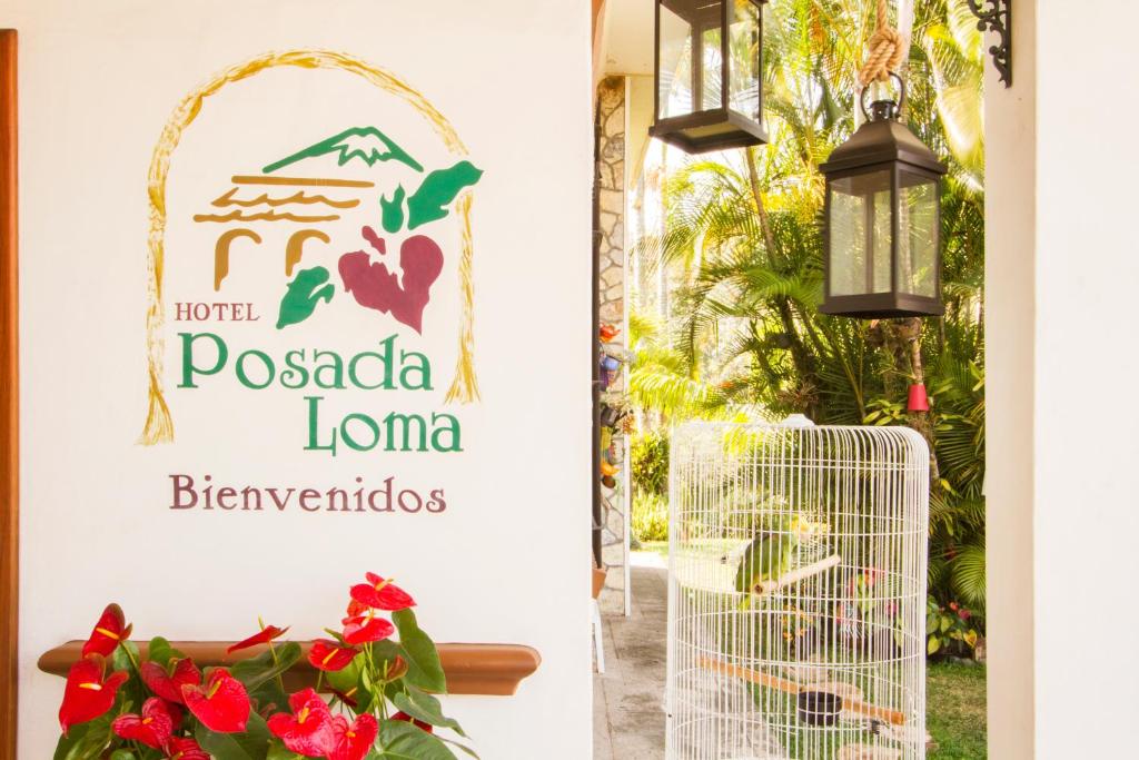 Fortín de las FloresHotel Posada Loma的鲜花餐厅入口的标志