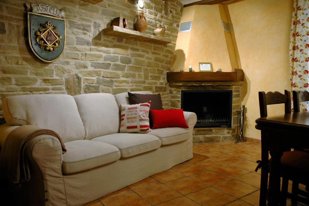 TodolellaA和B乡村鹦鹉公寓酒店的客厅配有白色沙发和壁炉