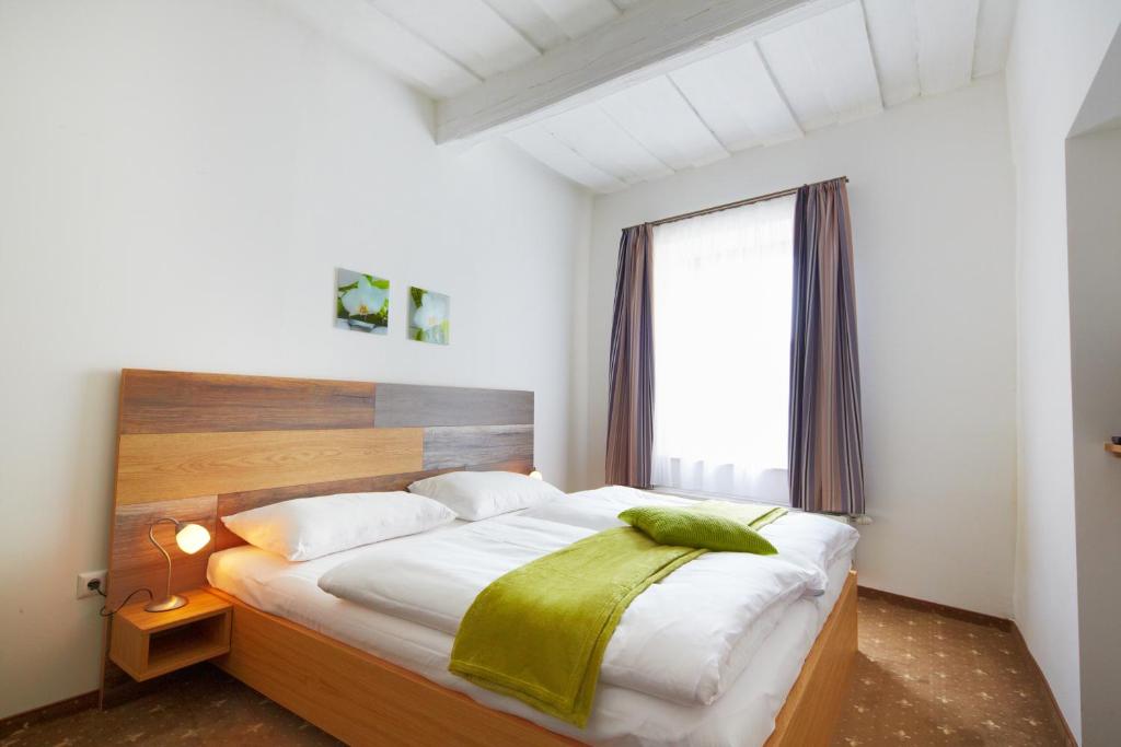 梅尔克拉特斯凯乐梅尔克公寓的一间卧室配有一张大床,上面有绿毯
