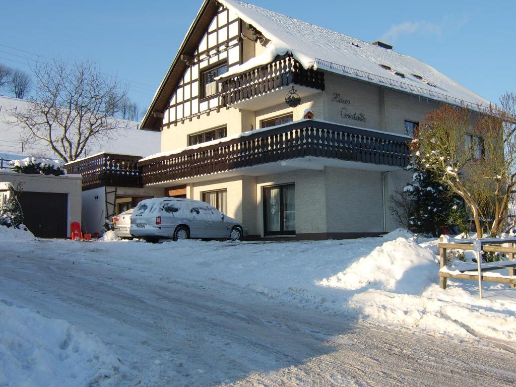奥尔斯贝格Haus Cristallo的雪中停放汽车的房子