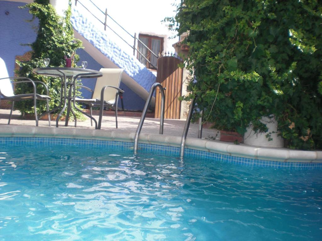 贝瑙卡斯Apartamentos Jaronil的一个带桌椅和楼梯的游泳池