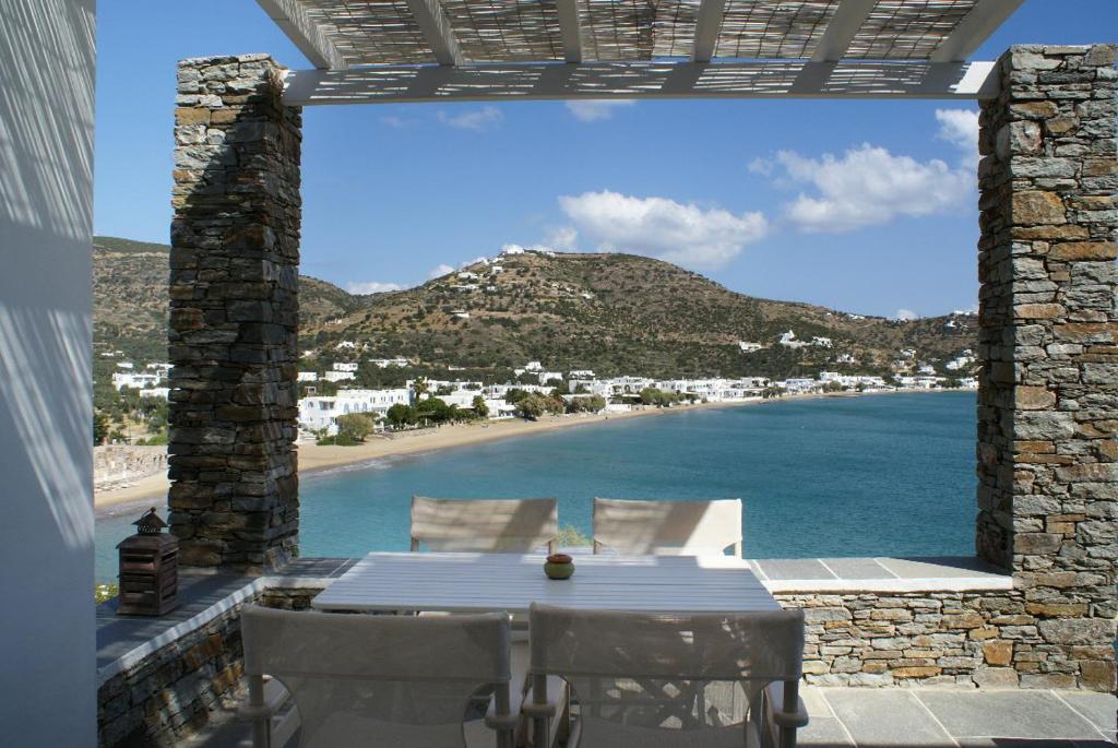 普拉提伊亚洛斯西弗诺斯Akrotiraki Apartments的一个带桌子并享有海滩美景的庭院