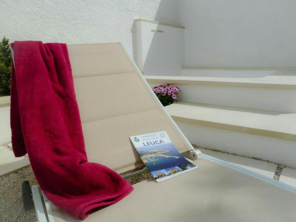 莱乌卡Residence Leucasia的坐在长凳上的红色袜子和书