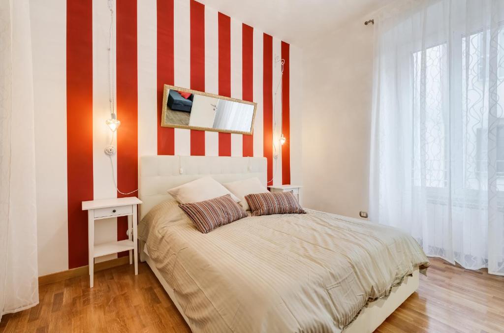 罗马圣科思玛托公寓的一间卧室配有一张红色和白色条纹的床