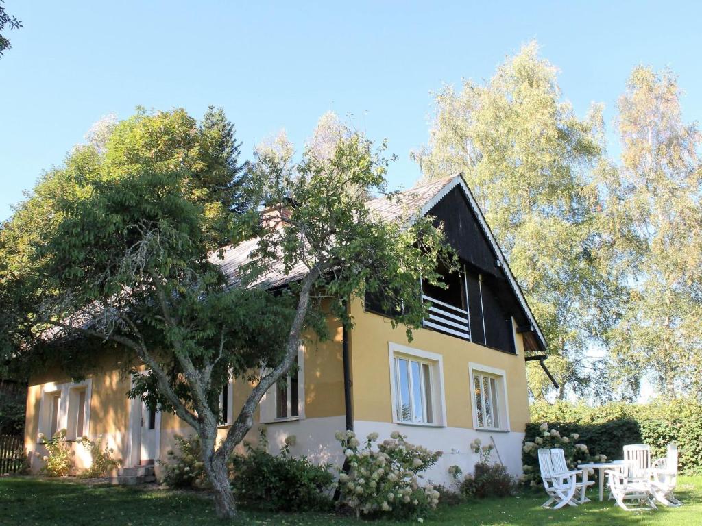 塔霍夫An eight person holiday home on a 1600 hectare的前面有一棵树的房子