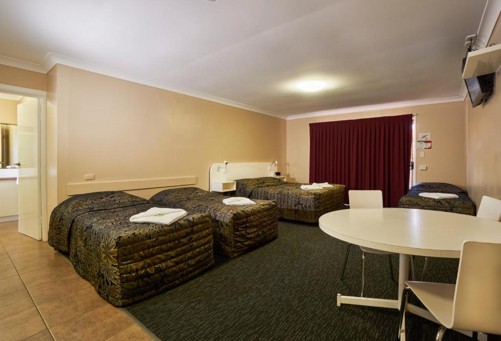 土乌巴杰弗里斯汽车旅馆的酒店客房设有两张床和一张桌子。