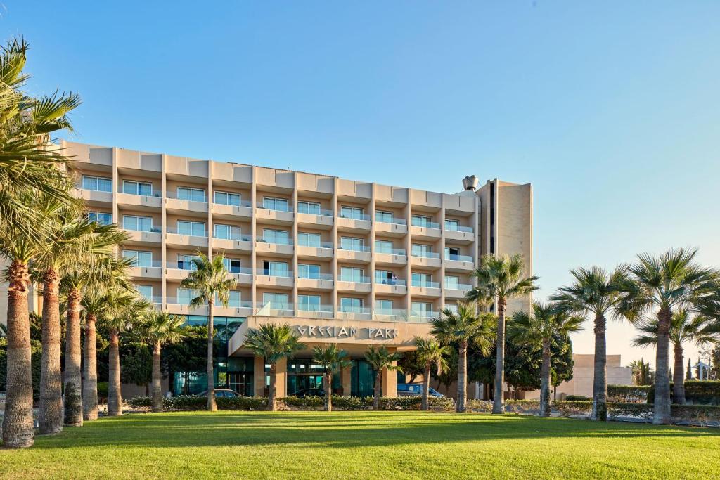 普罗塔拉斯格雷西安公园酒店的前面有棕榈树的酒店