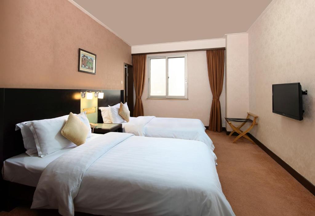 广州广州新华大酒店的酒店客房设有两张床和电视。