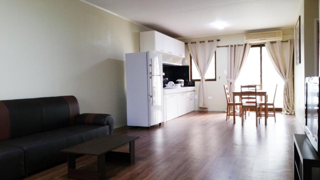 查兰卡诺亚塞班家庭公寓的带沙发和桌子的客厅以及厨房。