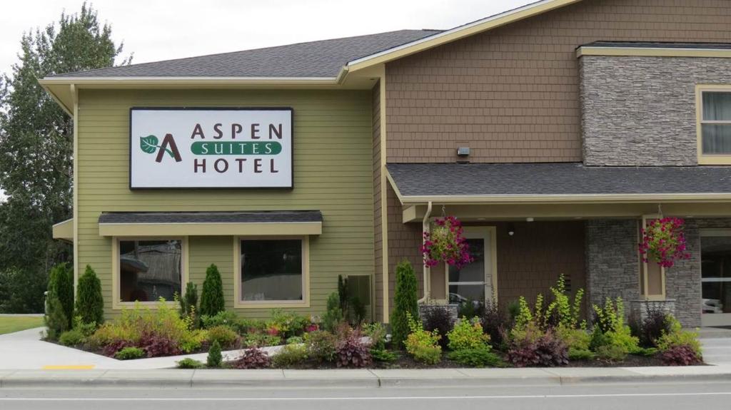 海恩斯Aspen Suites Hotel Haines的绿色建筑,带有Spa区标志