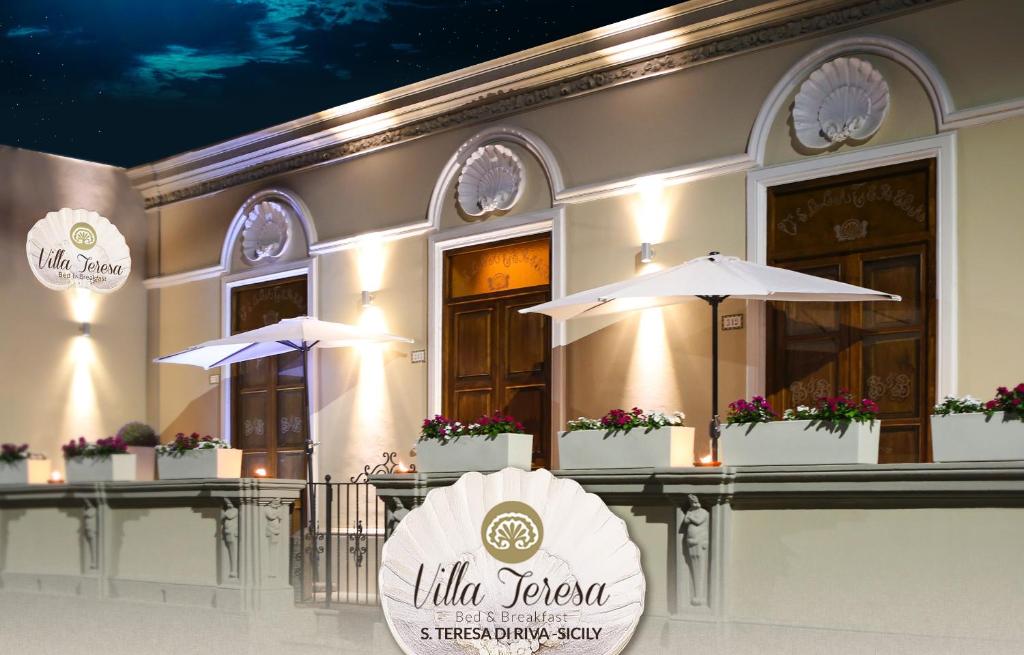 圣泰雷萨迪里瓦Villa Teresa的大楼前有标志的餐厅