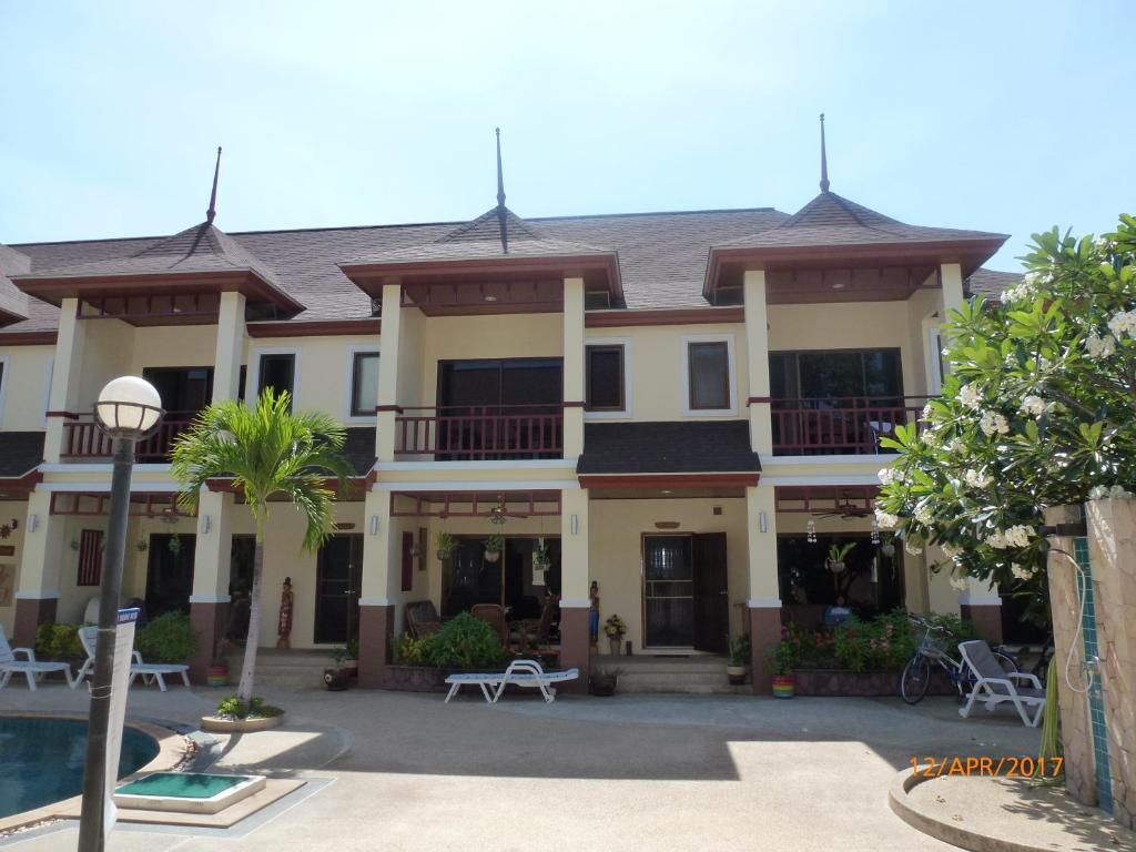 七岩Organgrinder Thai Paradise South的一座大型建筑,前面设有一个游泳池