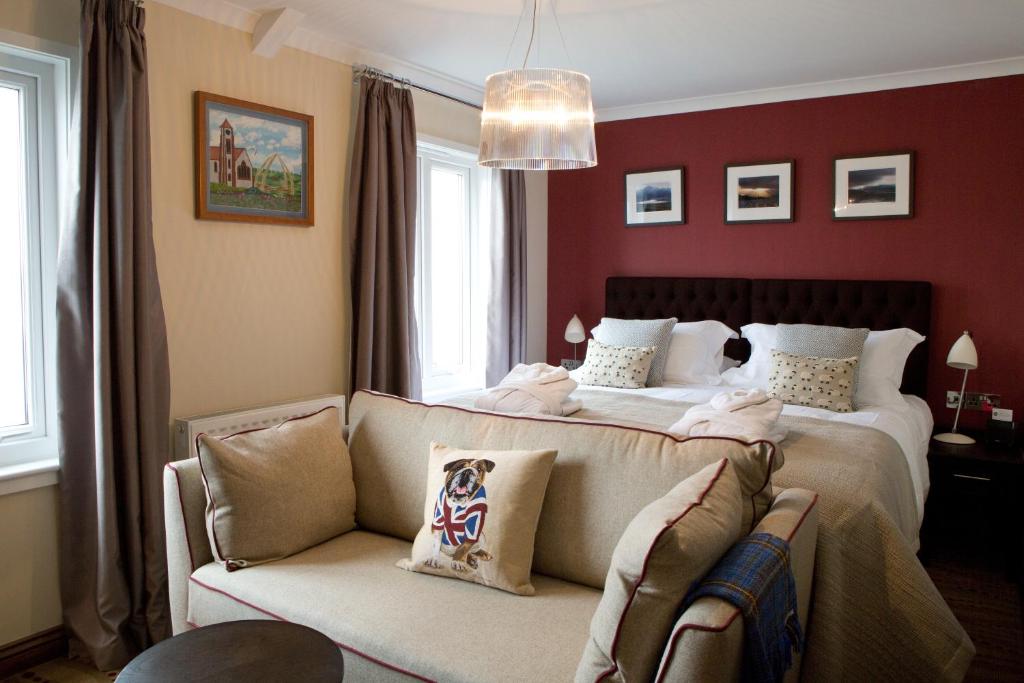 斯坦利海滨精品酒店的一间卧室配有一张大床和一张沙发