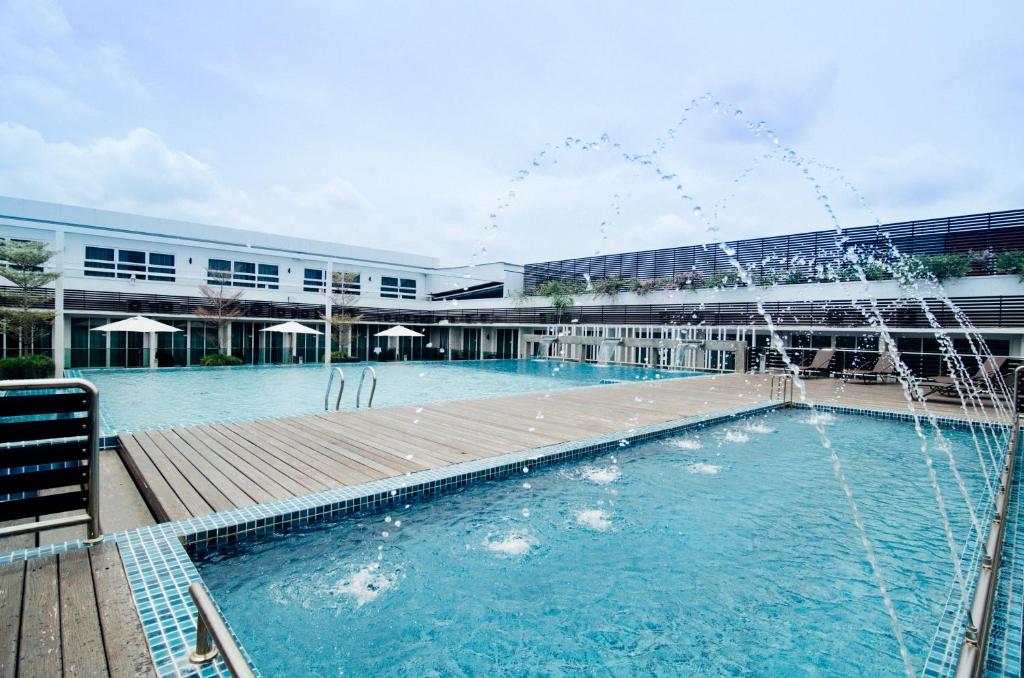 卢穆特斯费拉酒店的一座建筑前的游泳池,喷泉