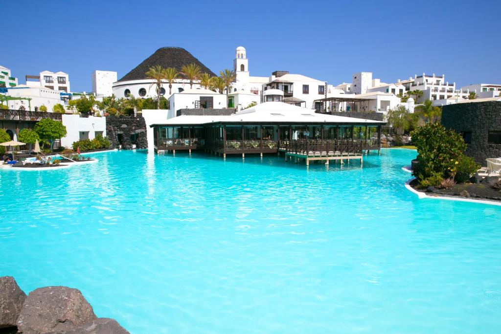 普拉亚布兰卡Hotel LIVVO Volcán Lanzarote的度假村内的一个大型蓝色海水游泳池