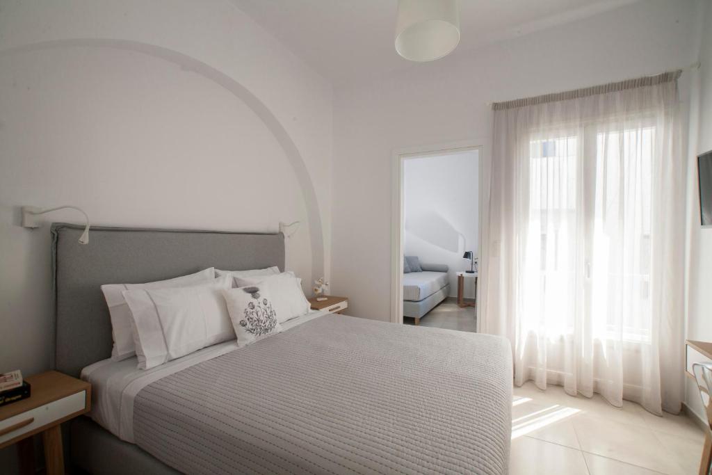 纳克索乔拉Aelia Apartments的一间卧室设有一张床和一个大窗户