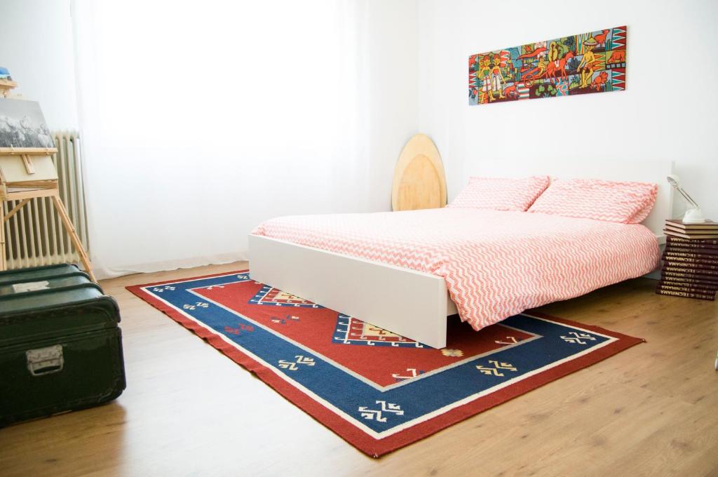 皮奥韦迪萨科Nanda house的地板上铺着地毯的房间的一张床位