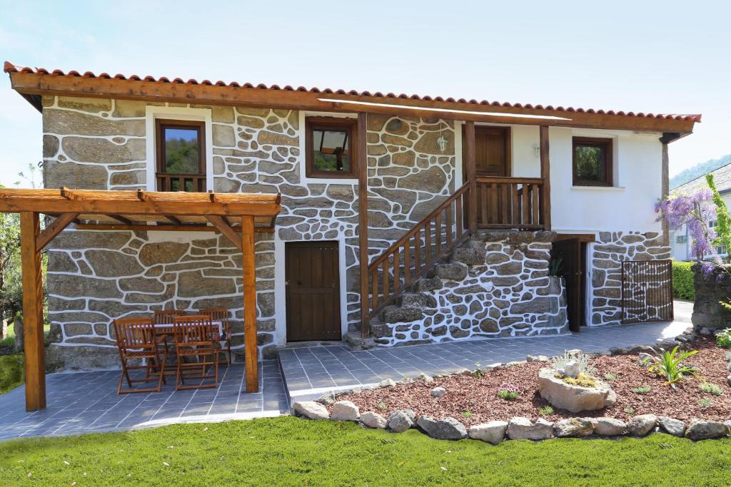 La TeijeiraCasa Juca的石头房子设有门廊和庭院