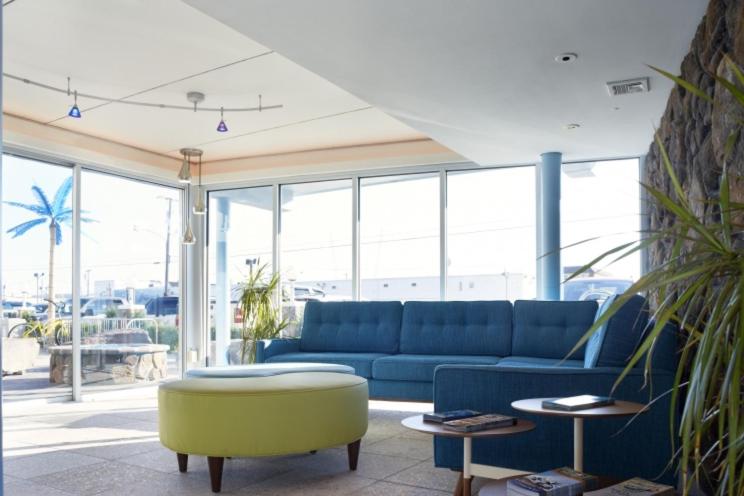 怀尔德伍德蓝色棕榈汽车旅馆的客厅配有蓝色的沙发和桌子