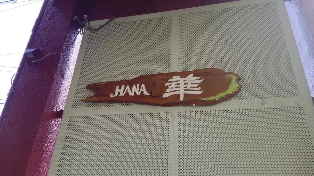 大津哈娜旅馆的墙上的标志,上面有卡玛标志