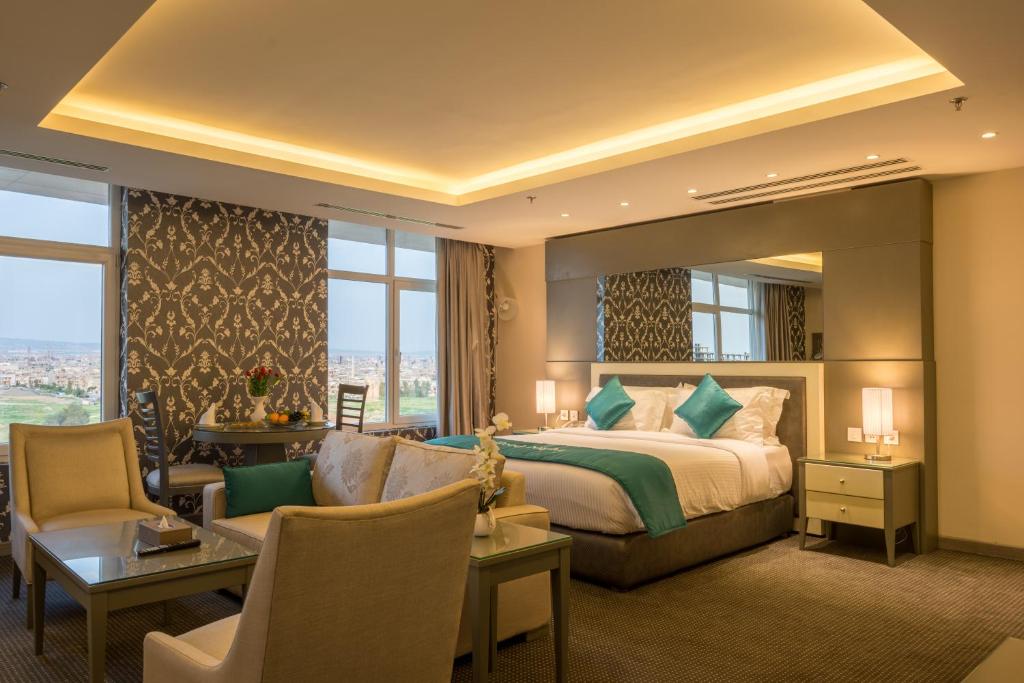埃尔比勒La Roche Hotel的酒店客房设有一张床和一个大窗户