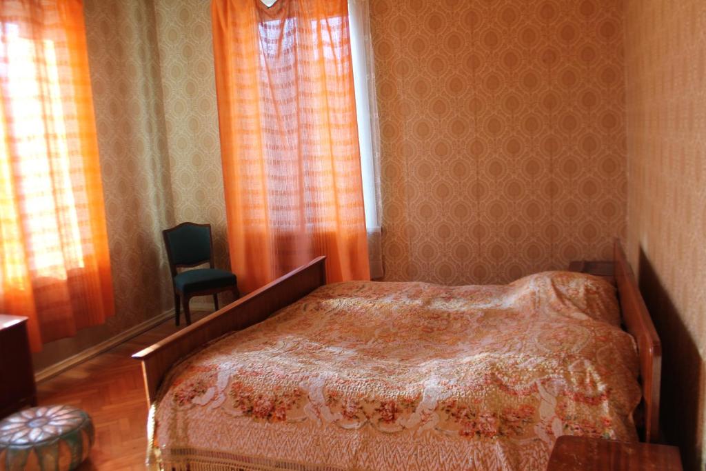 泰拉维TLT宾馆的一间卧室设有一张床、一个窗口和一把椅子