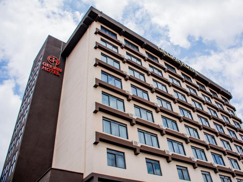 马查科斯Gelian Hotel的上面有红色标志的高大的白色建筑