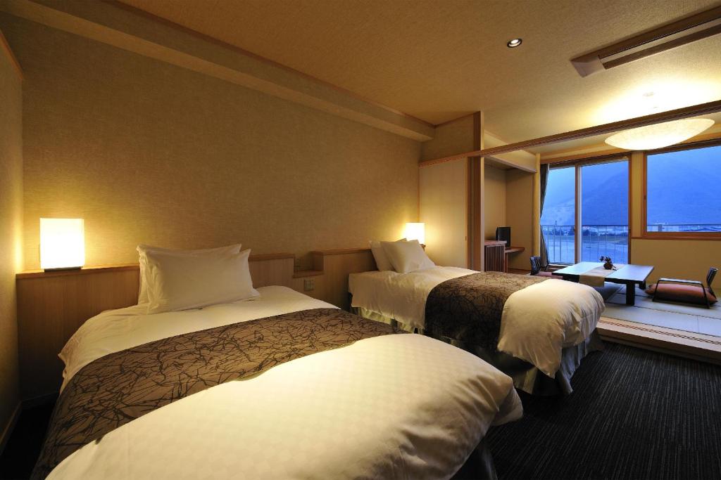 千曲市清风园酒店的酒店客房设有两张床和窗户。