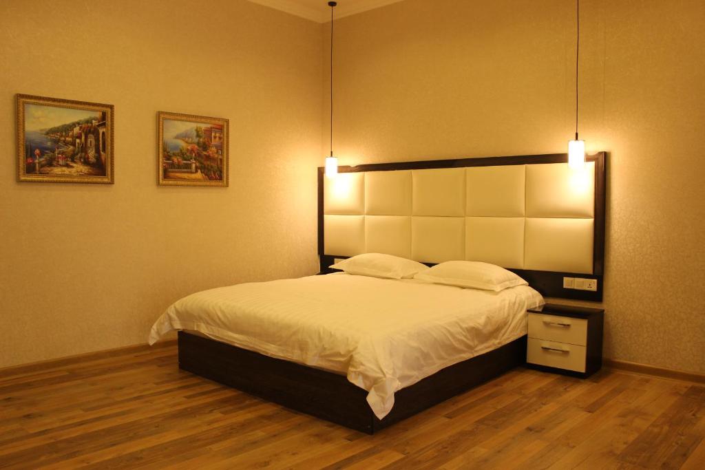 杜尚别阿特拉斯住宿加早餐旅馆的一间卧室配有一张大床,上面有灯