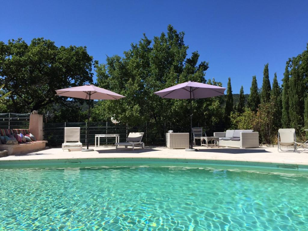 穆斯捷-圣玛丽勒雅杜科隆比耶酒店的一个带椅子和遮阳伞的游泳池